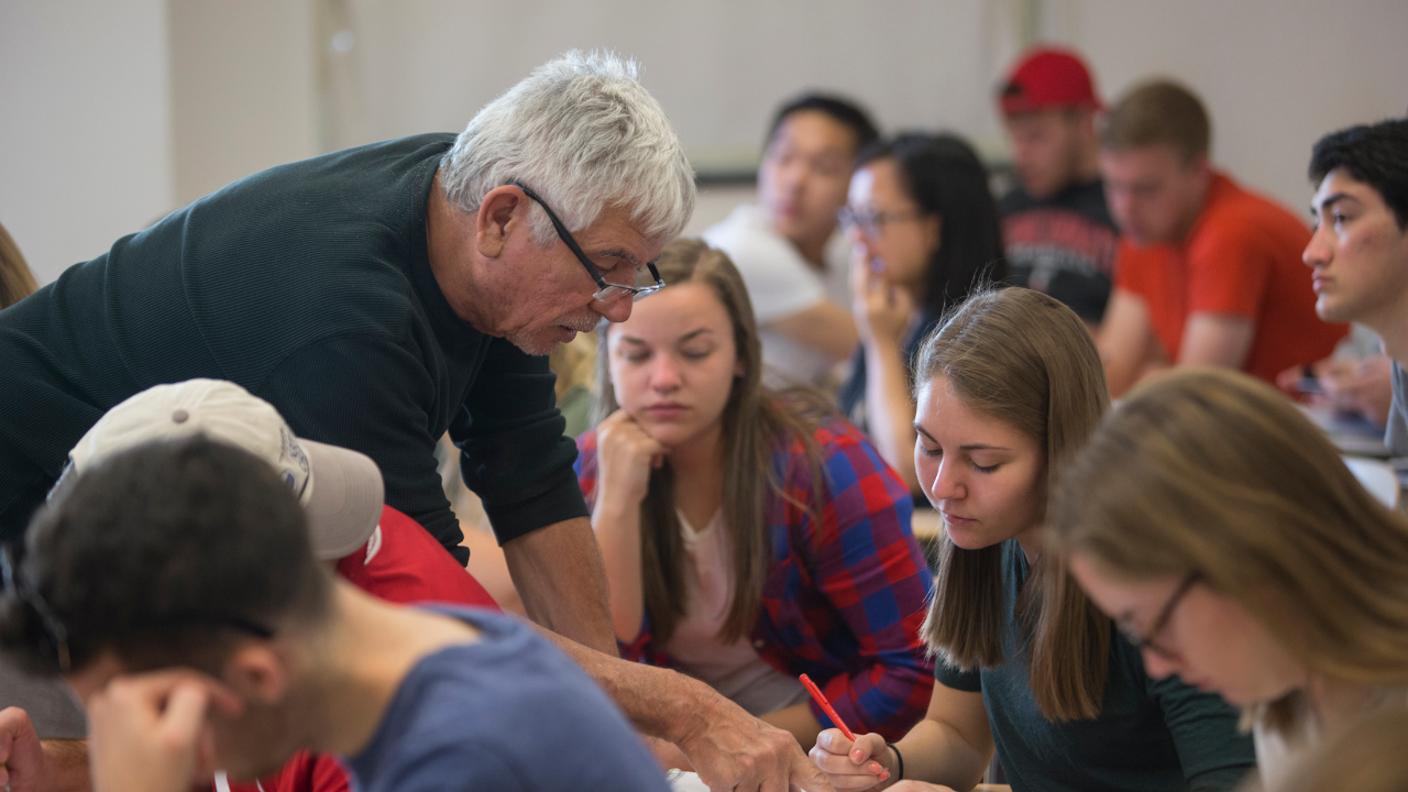 Professor engaging with student in class